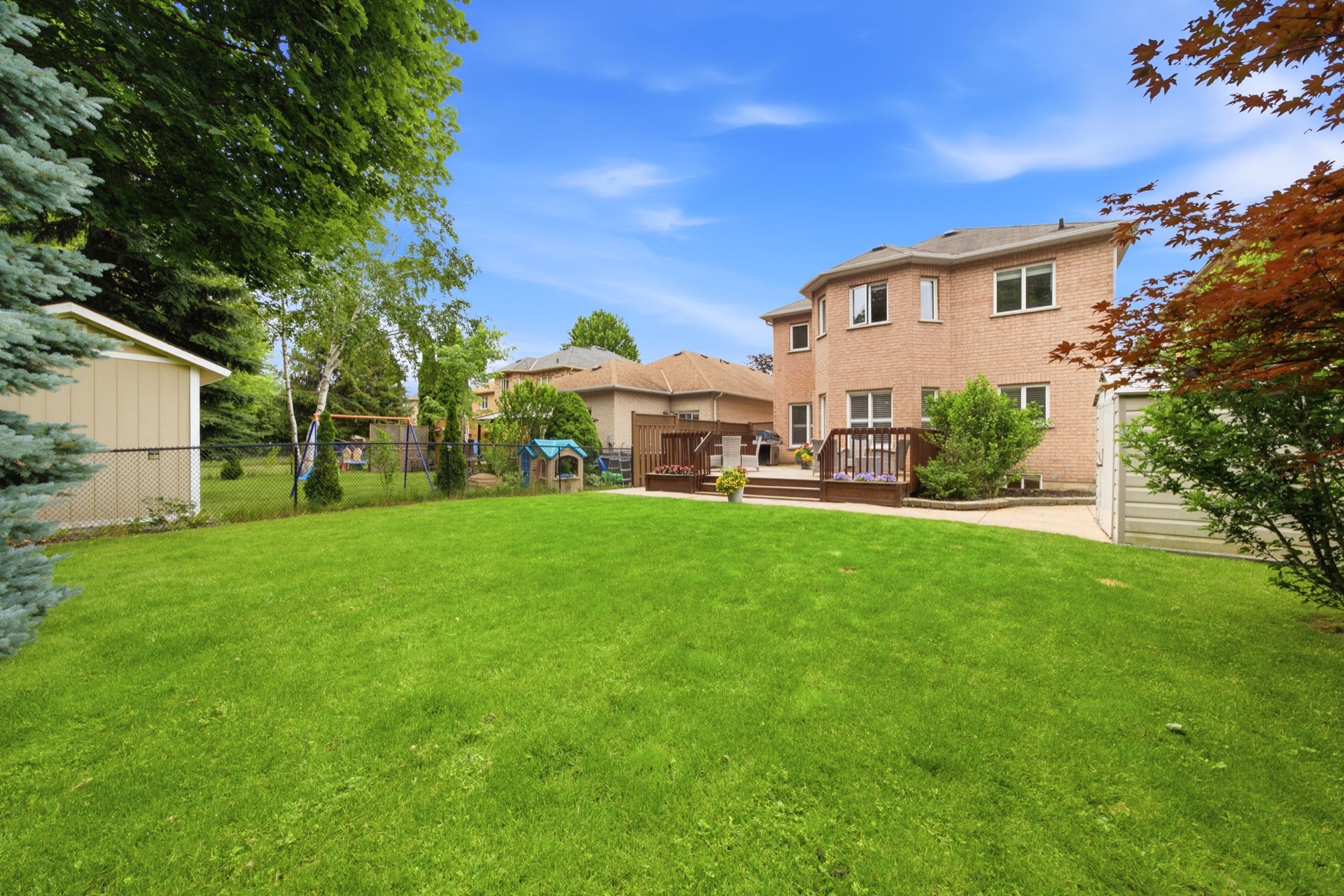 Backyard view of 7287 Waldorf Way showing the full lot and house
